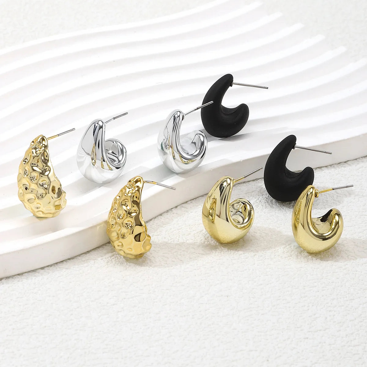 Elegant tear drop party earrings in gold, silver, and black for stylish occasions