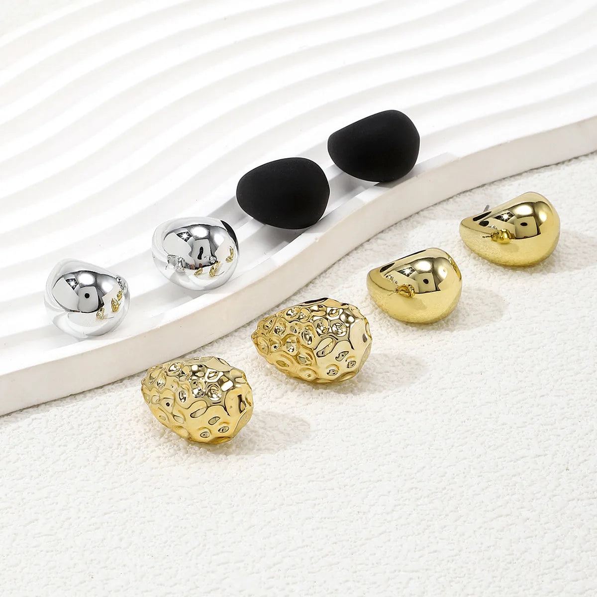 Elegant tear drop party earrings in silver, gold, and black designs for stylish occasions